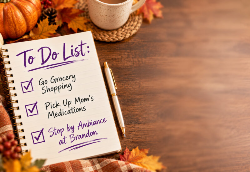 Holiday to-do list with checked tasks for grocery shopping, picking up Mom’s medications and stopping by Ambiance at Brandon, surrounded by fall decorations.